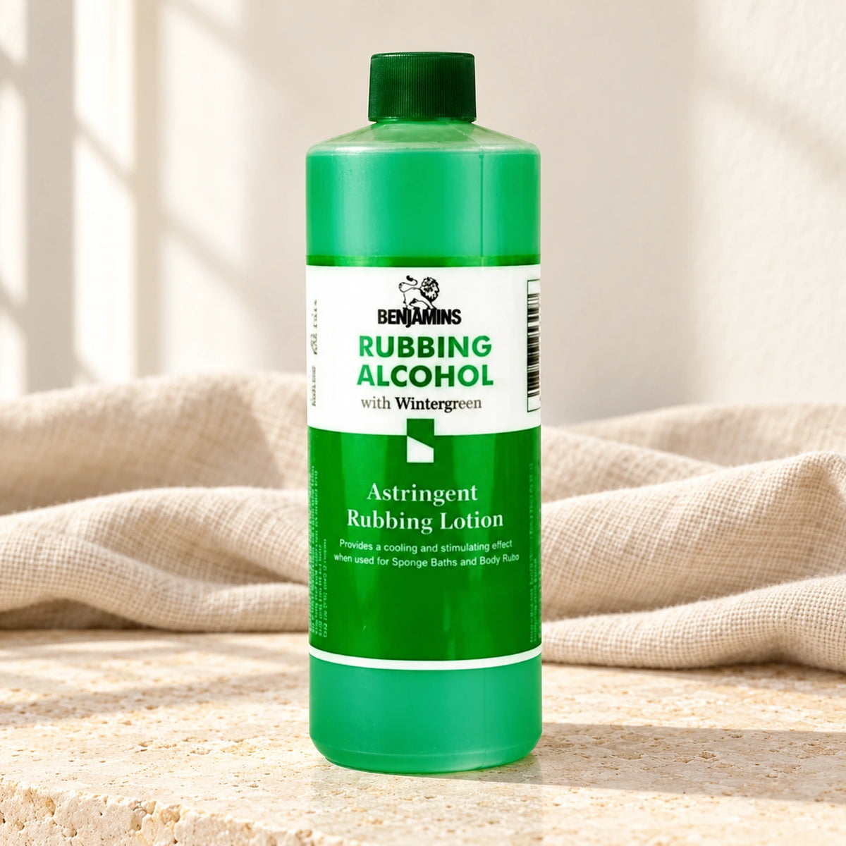Benjamins Rubbing Alcohol with Wintergreen bottle on pale stone with neutral linen