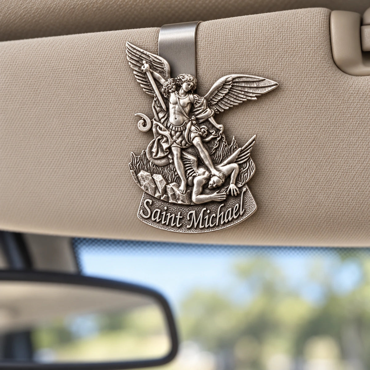 Saint Michael Pewter Car Visor Clip attached to a car sun visor