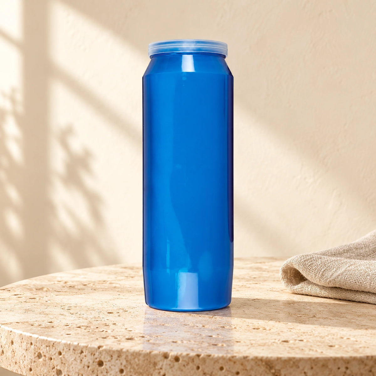 Blue CBC 9-day sanctuary candle styled on pale stone with linen