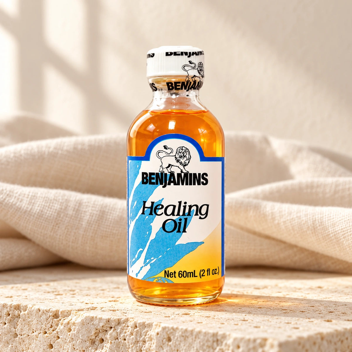 Benjamins Healing Oil 60ml bottle on pale stone with neutral linen