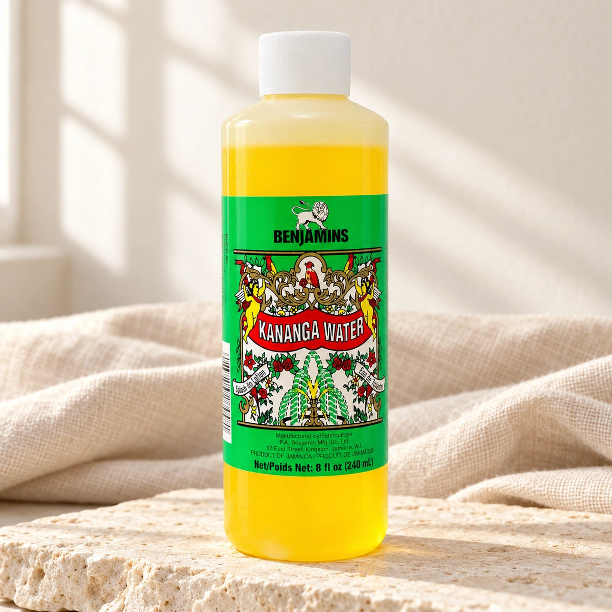 Benjamins Kananga Water 240ml bottle on pale stone with neutral linen
