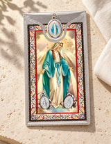 Miraculous Medal & Foil Leaflet Prayer Card styled on pale stone with linen