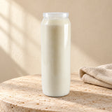White CBC 9-day sanctuary candle styled on pale stone with linen