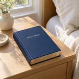 Hampton Text Bible – Blue Hardback on a bedside table