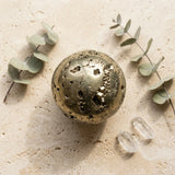 Tumbled mineral sphere — Spiritual Wellness Flat Lay | Generated by Modelize