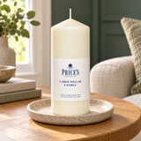 Price’s 6 inch ivory pillar candle styled on a candle plate in a sunlit home; plate and other props are not included.